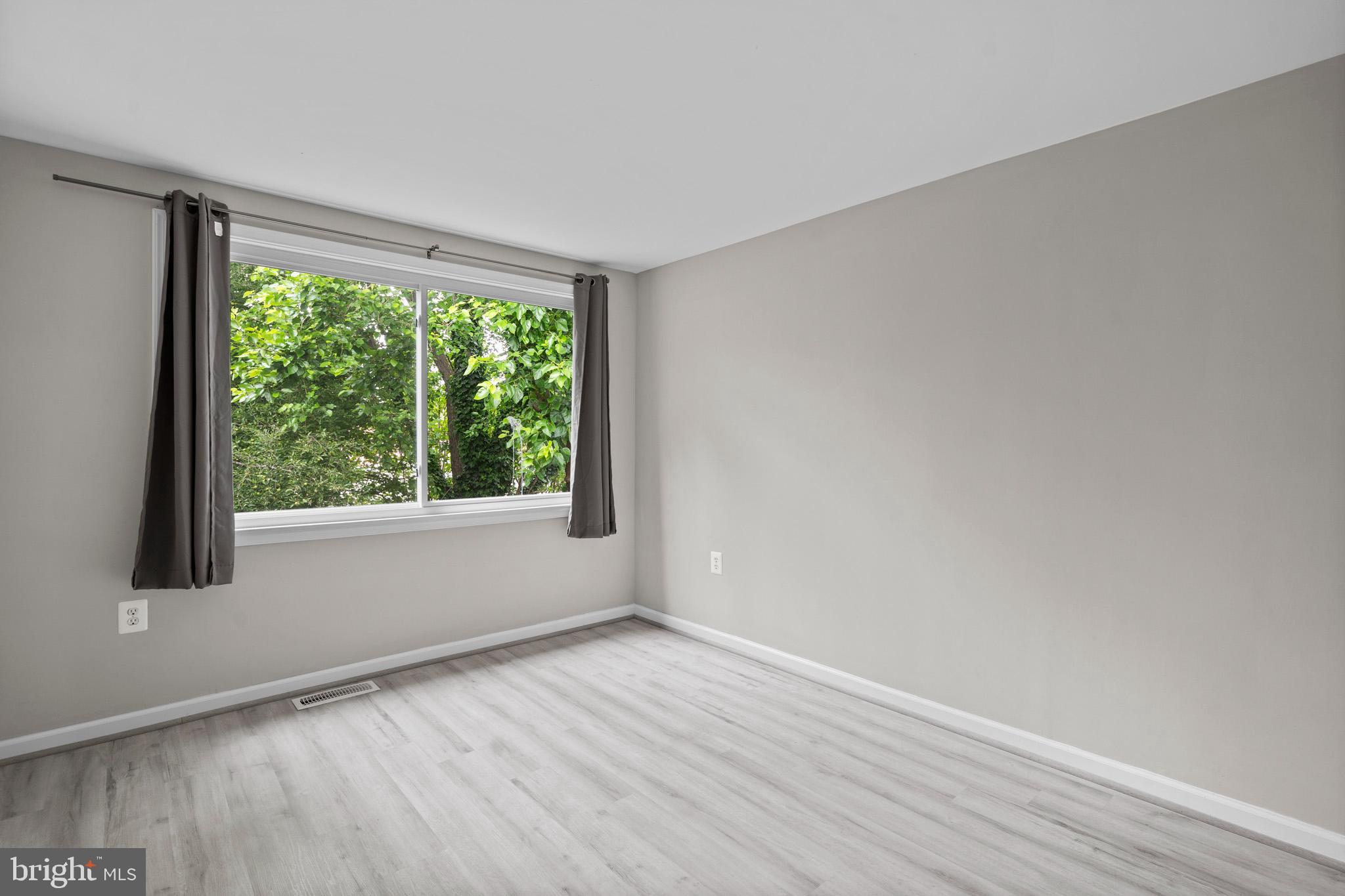 5908 Michael Road Waldorf, MD 20601 - Photo 25 of 44 a view of an empty room with wooden floor and a window