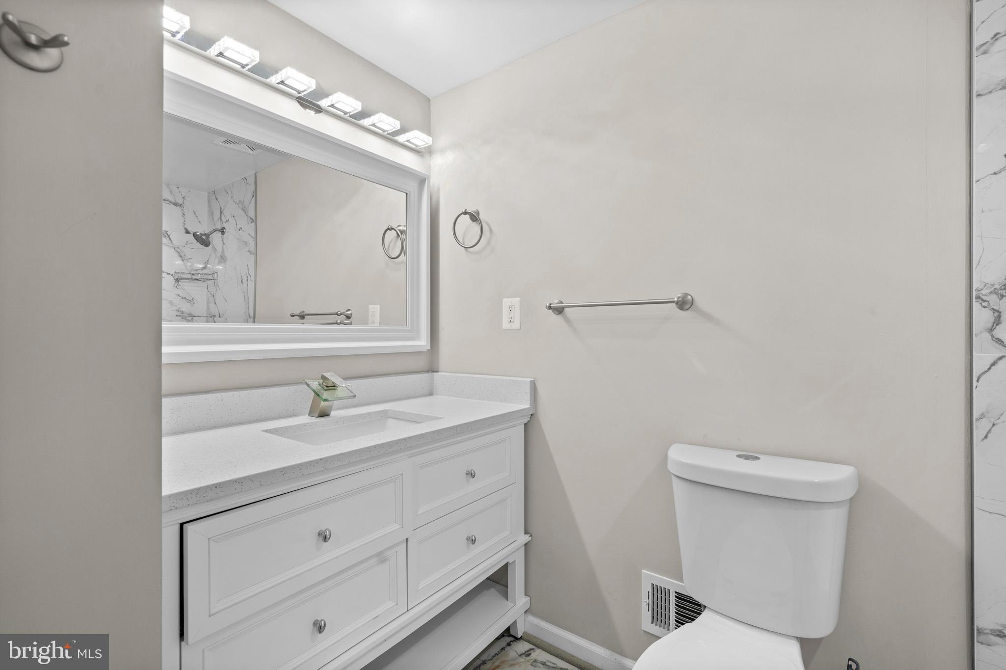 5908 Michael Road Waldorf, MD 20601 - Photo 28 of 44 a bathroom with a toilet sink and mirror