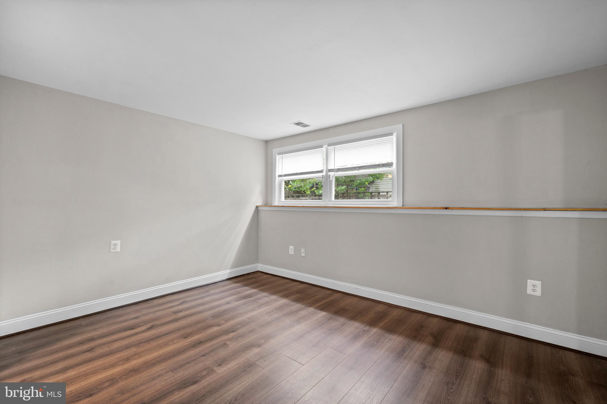 5908 Michael Road Waldorf, MD 20601 - Photo 34 of 44 an empty room with wooden floor and windows