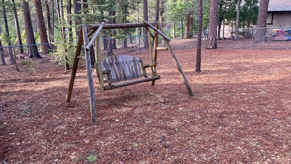 a view of a house with a wooden deck and a back yard
