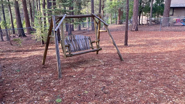 a view of a house with a wooden deck and a back yard