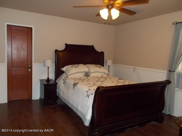 501 2nd Street Groom, TX 79039 - Photo 16 of 19 a bedroom with a bed and a chandelier