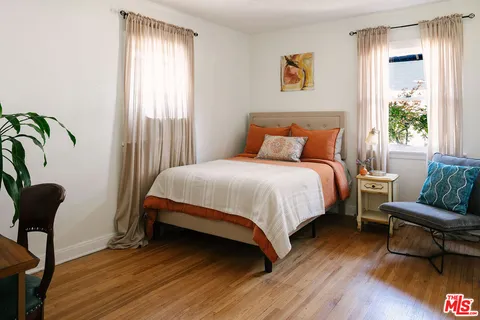 a bedroom with a bed and a chair