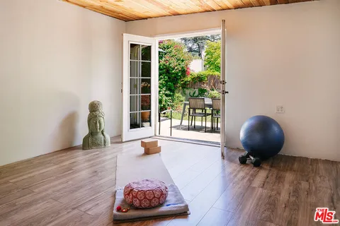 a living room filled with furniture and a floor to ceiling window