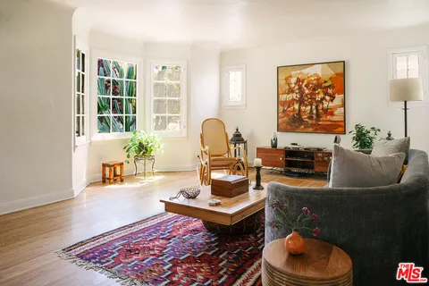 a living room with furniture and a potted plant