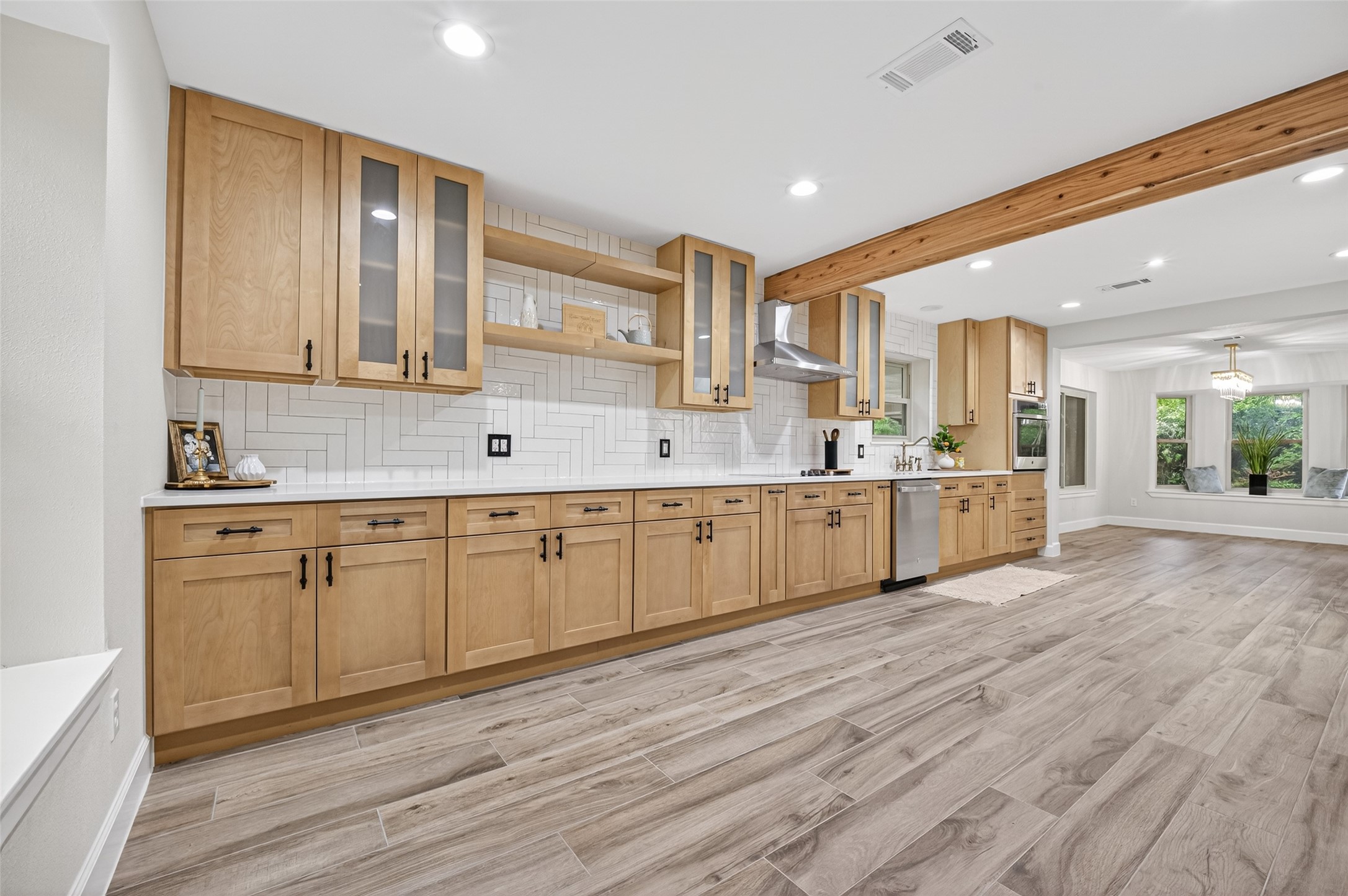 23607 Cardinal Drive Hockley, TX 77447 - Photo 15 of 50 Gorgeous wood-finish cabinetry lines the kitchen, perfectly complemented by a newly installed ceramic backsplash that adds a layer of refined texture.