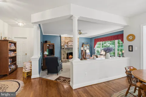 a living room with furniture a rug and a window