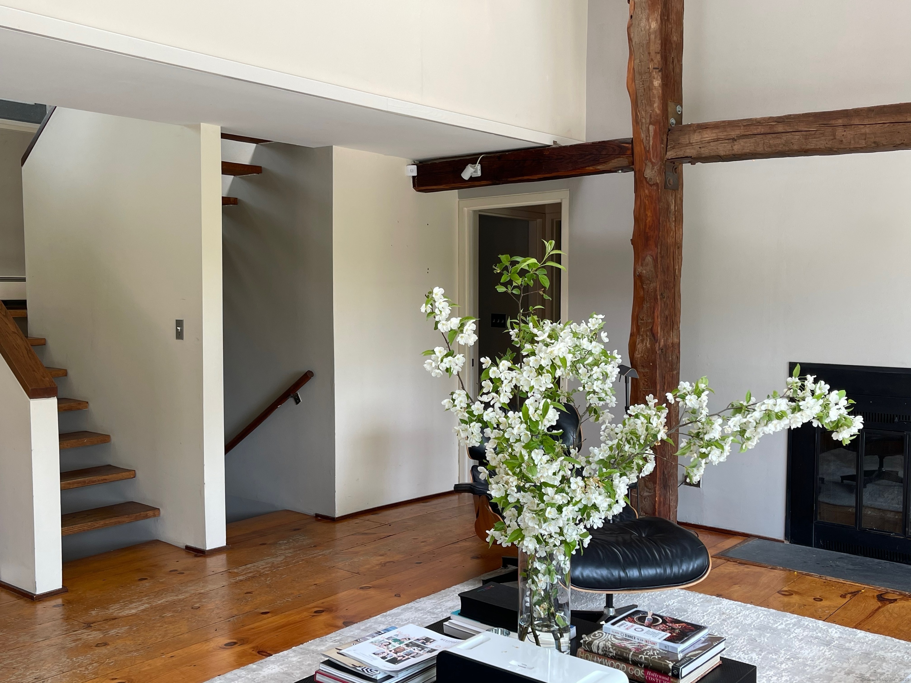 58 Wells Hill Road Weston, CT 06883 - Photo 11 of 38 a view of a hallway with wooden floor and a potted plant
