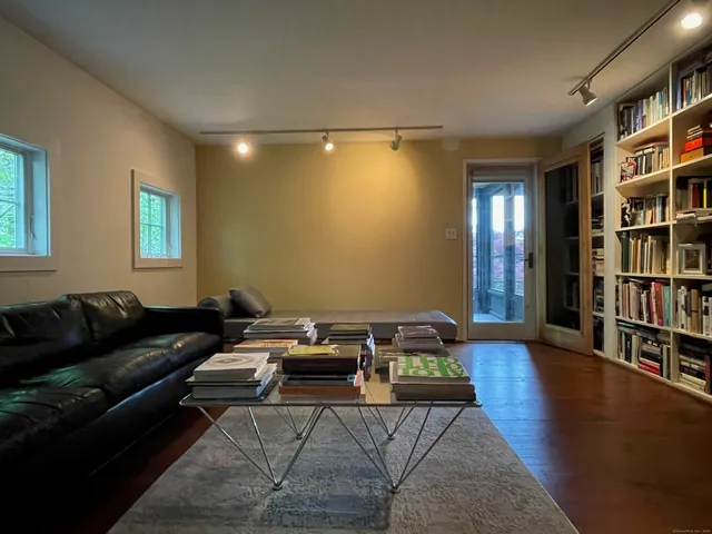 a living room with furniture and a book shelf