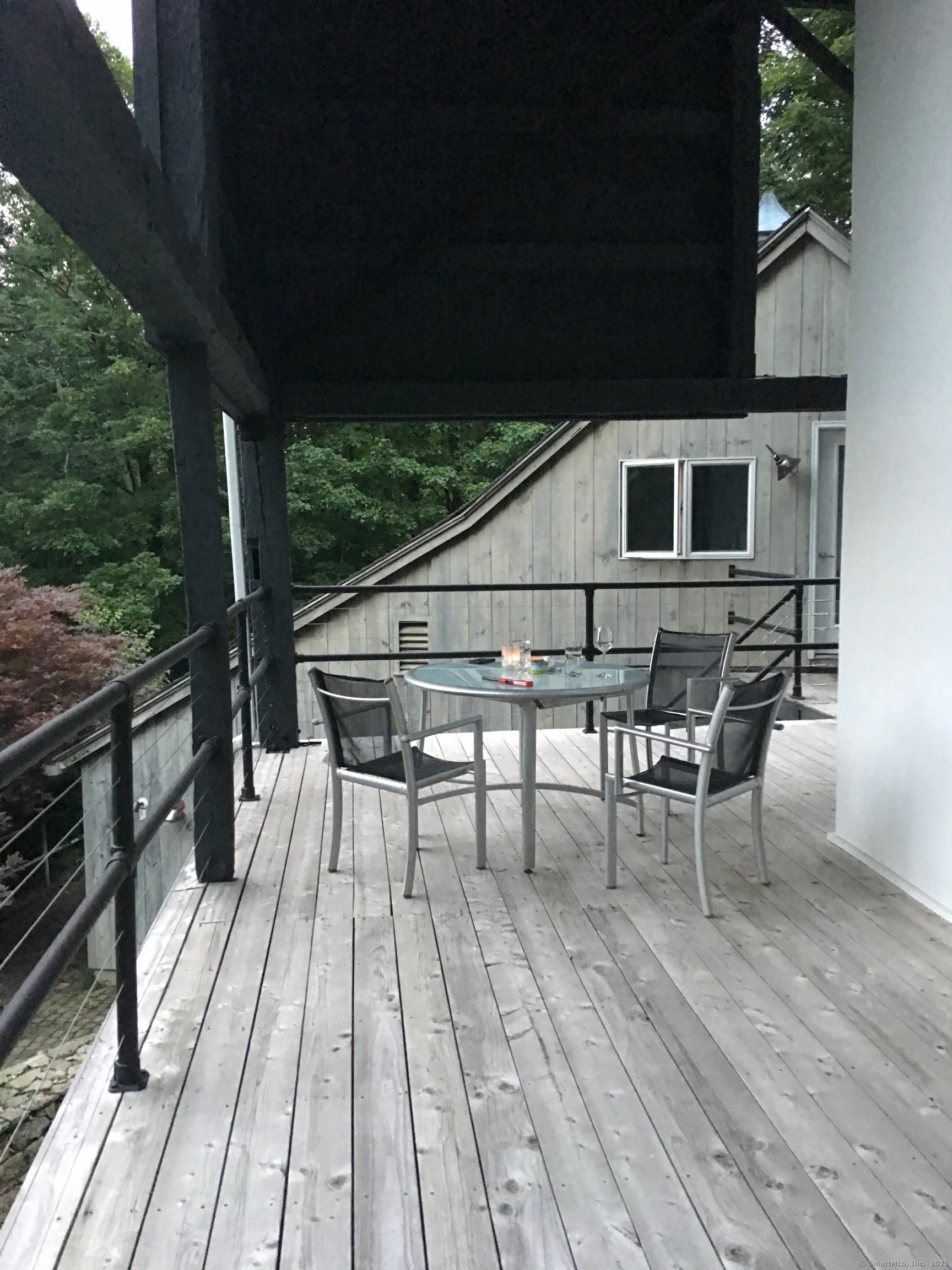 58 Wells Hill Road Weston, CT 06883 - Photo 14 of 38 a roof deck with table and chairs with wooden floor