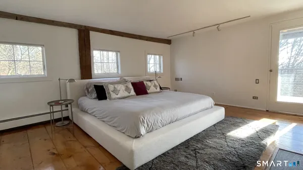 a bedroom with a bed and window