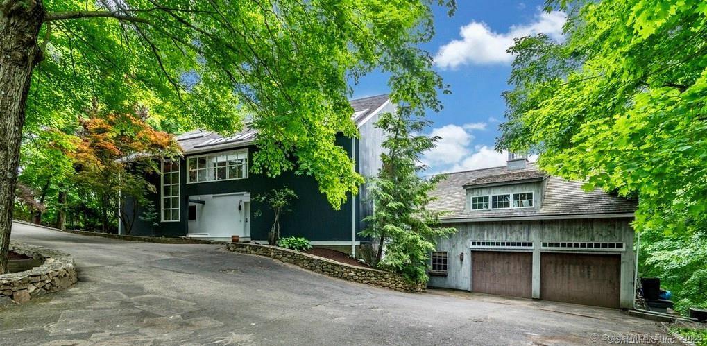 58 Wells Hill Road Weston, CT 06883 - Photo 2 of 38 front view of a house with a plants and trees