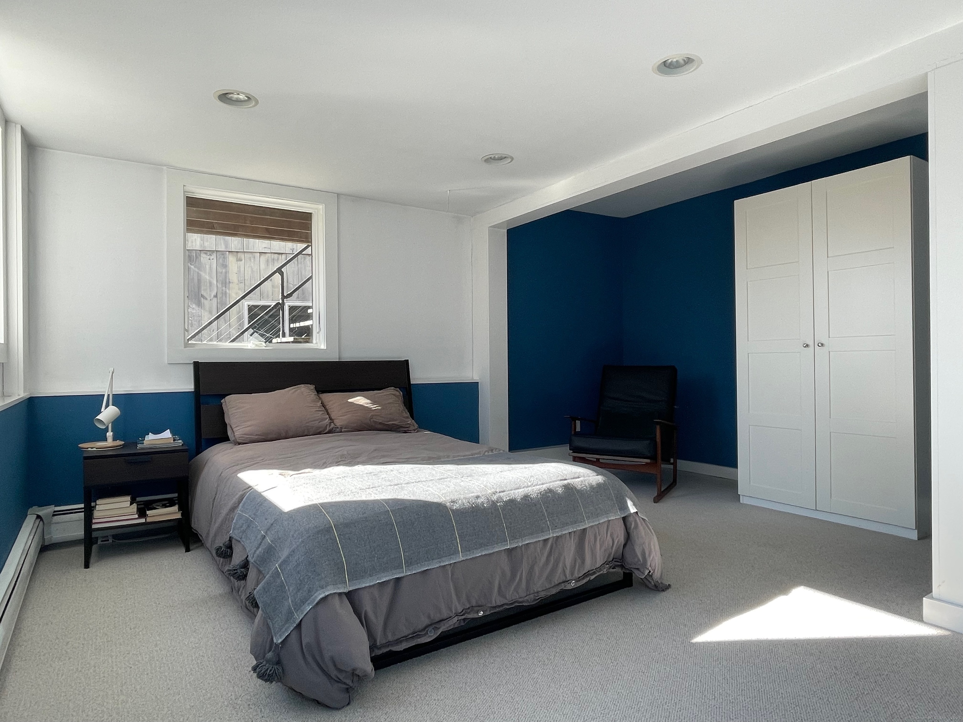 58 Wells Hill Road Weston, CT 06883 - Photo 27 of 38 a bedroom with a bed a table and painting