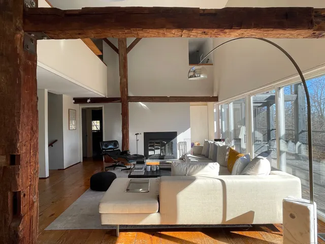 a living room with furniture a fireplace and a table