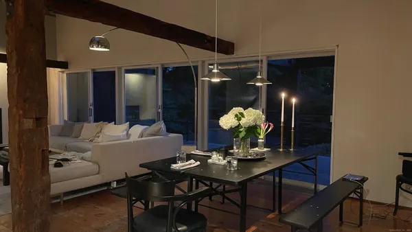 a living room with furniture and potted plants