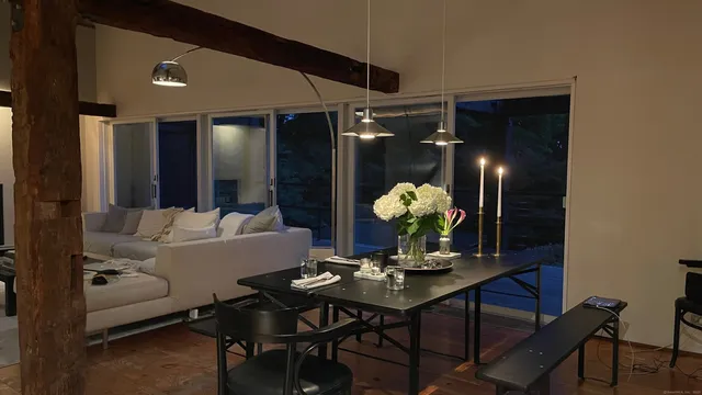 a living room with furniture and potted plants