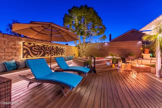 a view of a roof deck with table and chairs with wooden floor