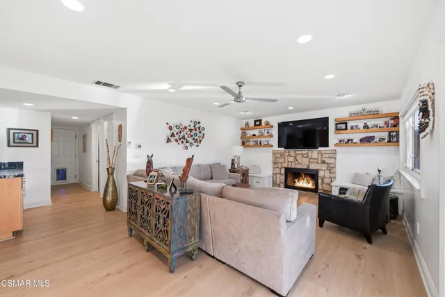 a living room with furniture and kitchen view