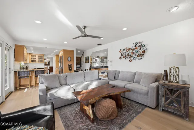 a kitchen with a table chairs refrigerator and microwave