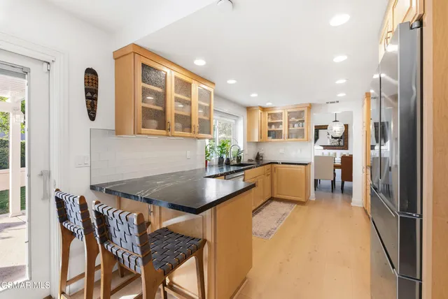 a kitchen with stainless steel appliances a sink stove and cabinets