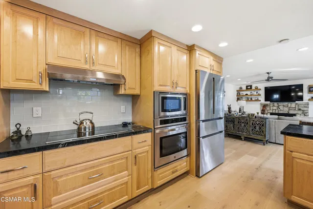 a view of a kitchen with furniture and wooden floor