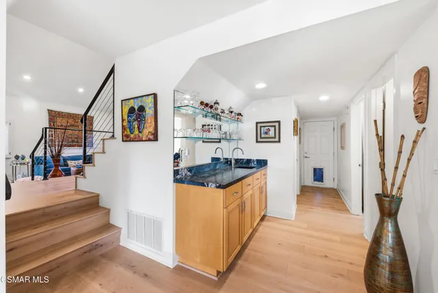 a bathroom with a granite countertop sink a toilet and shower