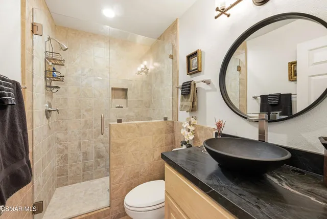 a bedroom with furniture and a large window