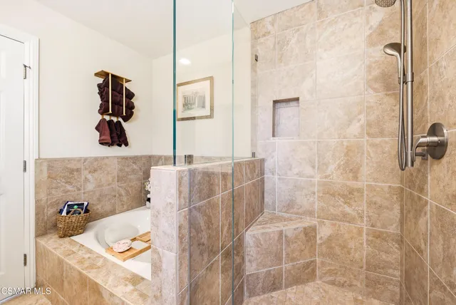 a bathroom with a tub sink and mirror