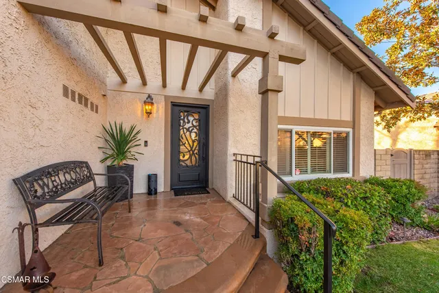 a view of house with outdoor seating and stairs