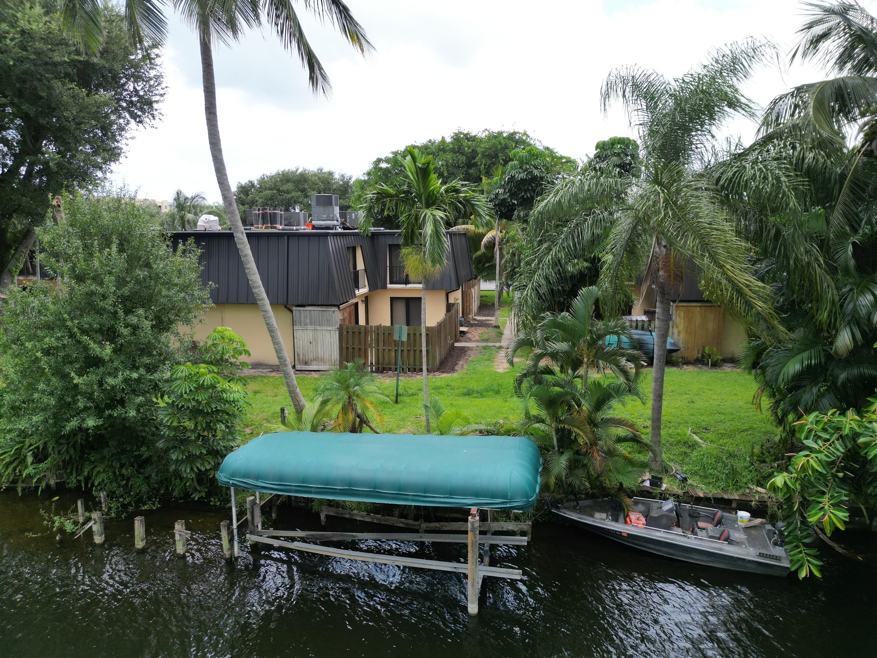 2438 Waterside Drive Lake Worth, FL 33461 - Photo 22 of 26 a backyard of a house with lots of green space and outdoor seating