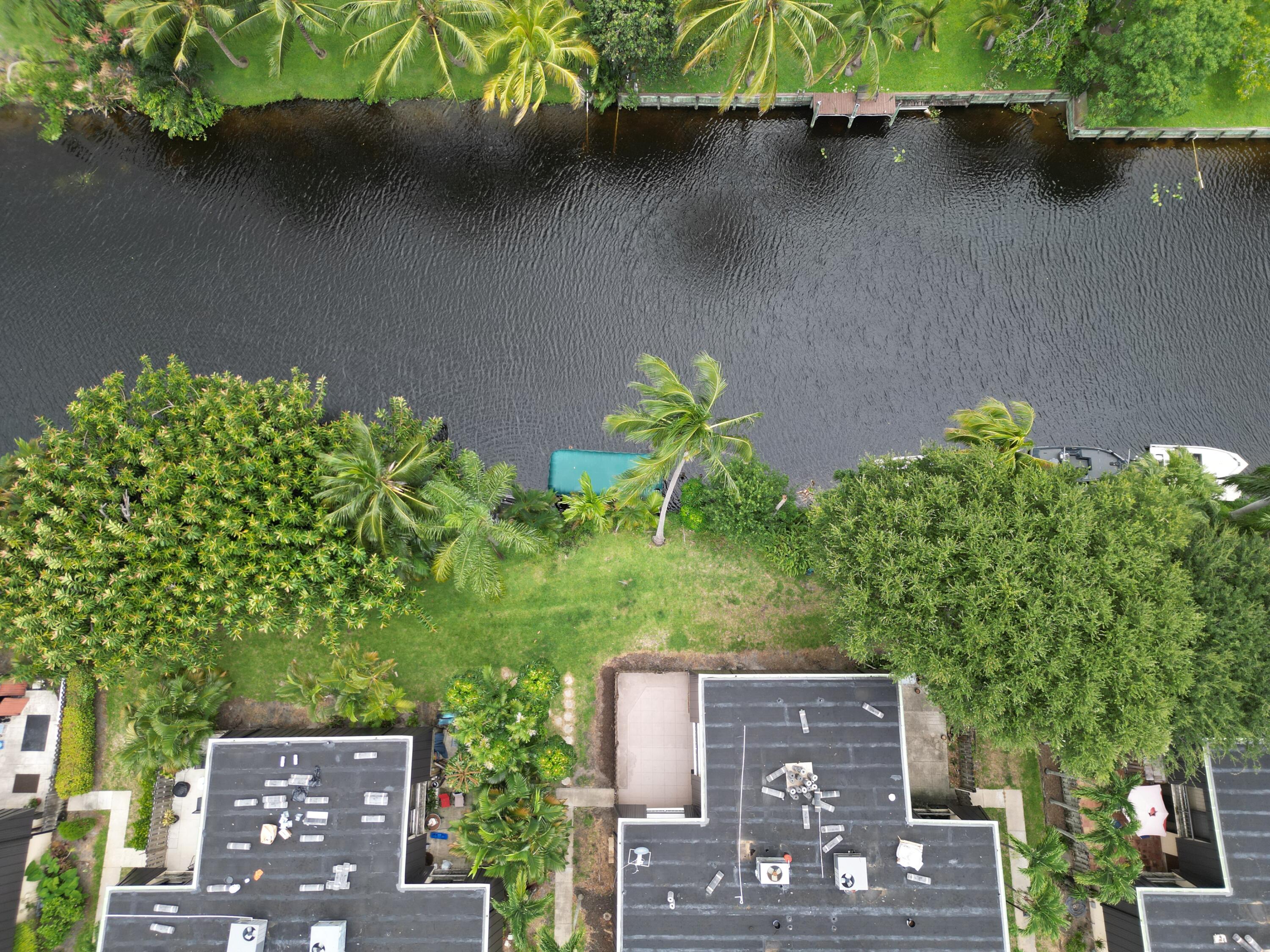 2438 Waterside Drive Lake Worth, FL 33461 - Photo 25 of 26 an aerial view of a house with a yard and a bench