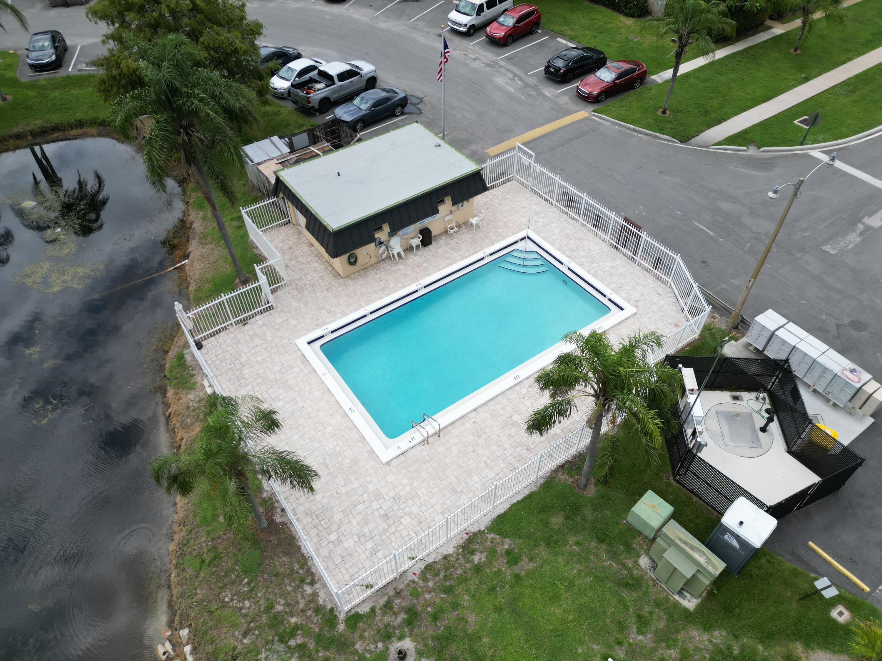 2438 Waterside Drive Lake Worth, FL 33461 - Photo 26 of 26 an aerial view of a house with a garden and trees