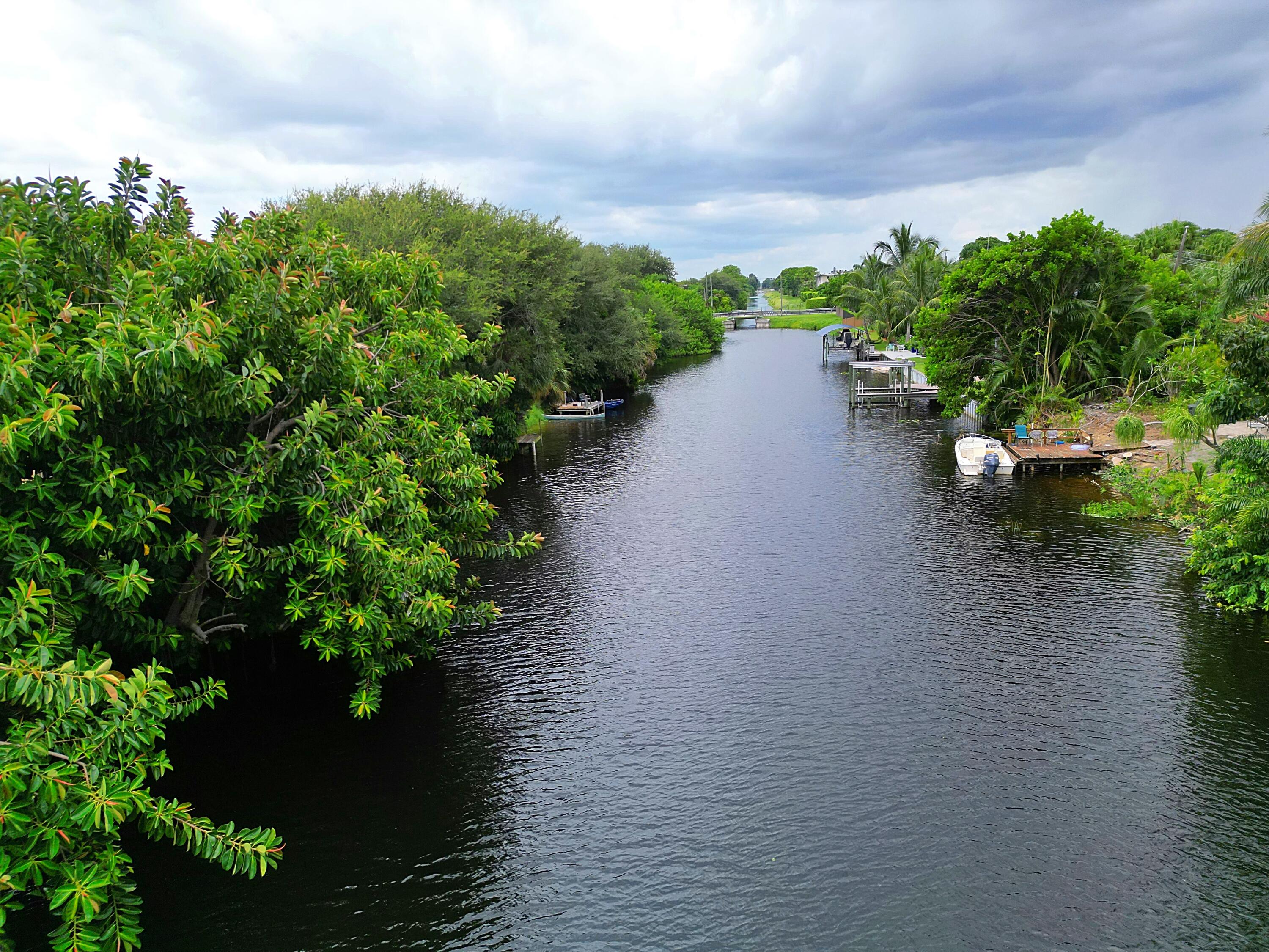 2438 Waterside Drive Lake Worth, FL 33461 - Photo 3 of 26 a view of a lake with a yard