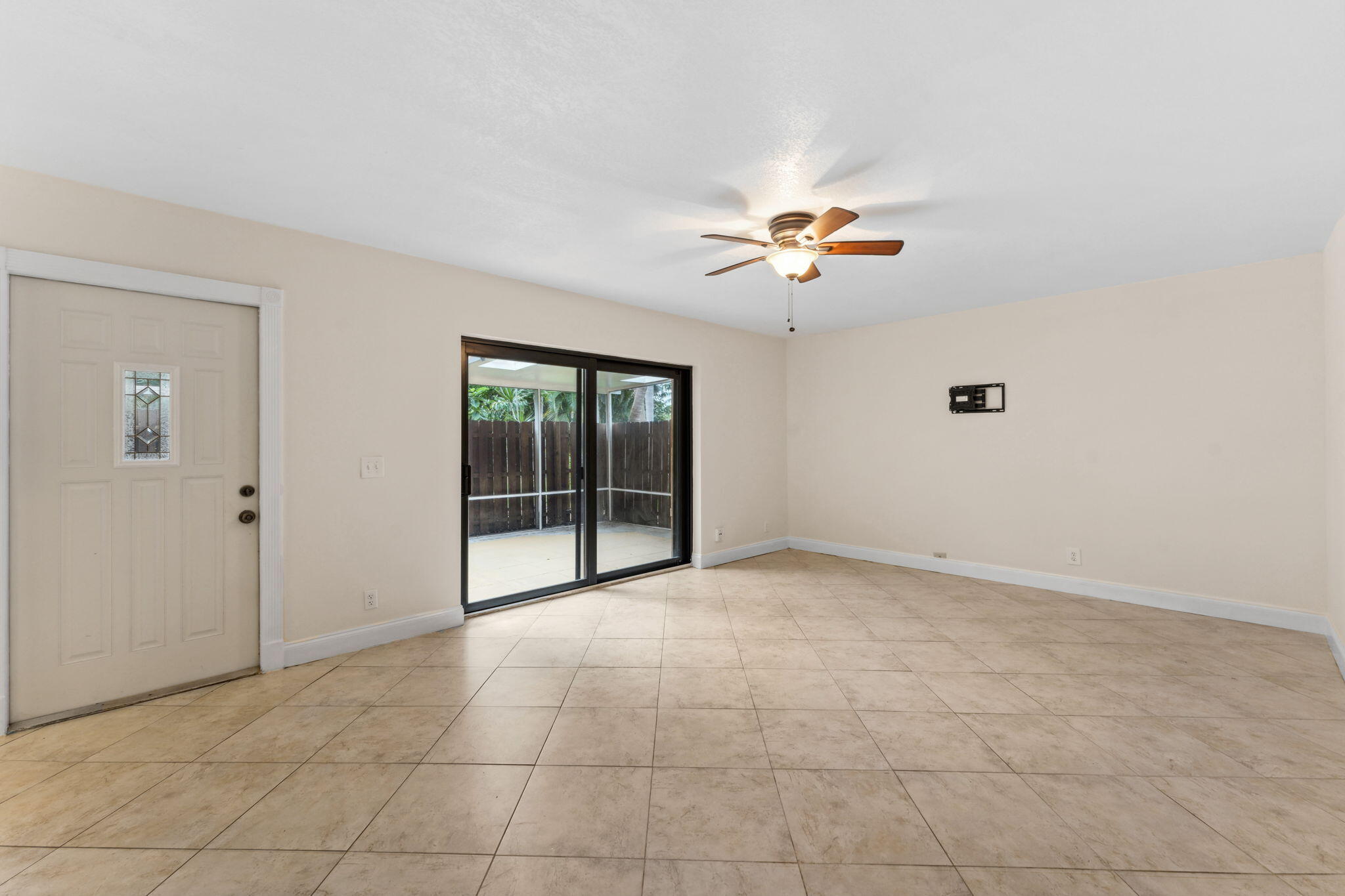 2438 Waterside Drive Lake Worth, FL 33461 - Photo 5 of 26 a view of an empty room with a ceiling fan and window