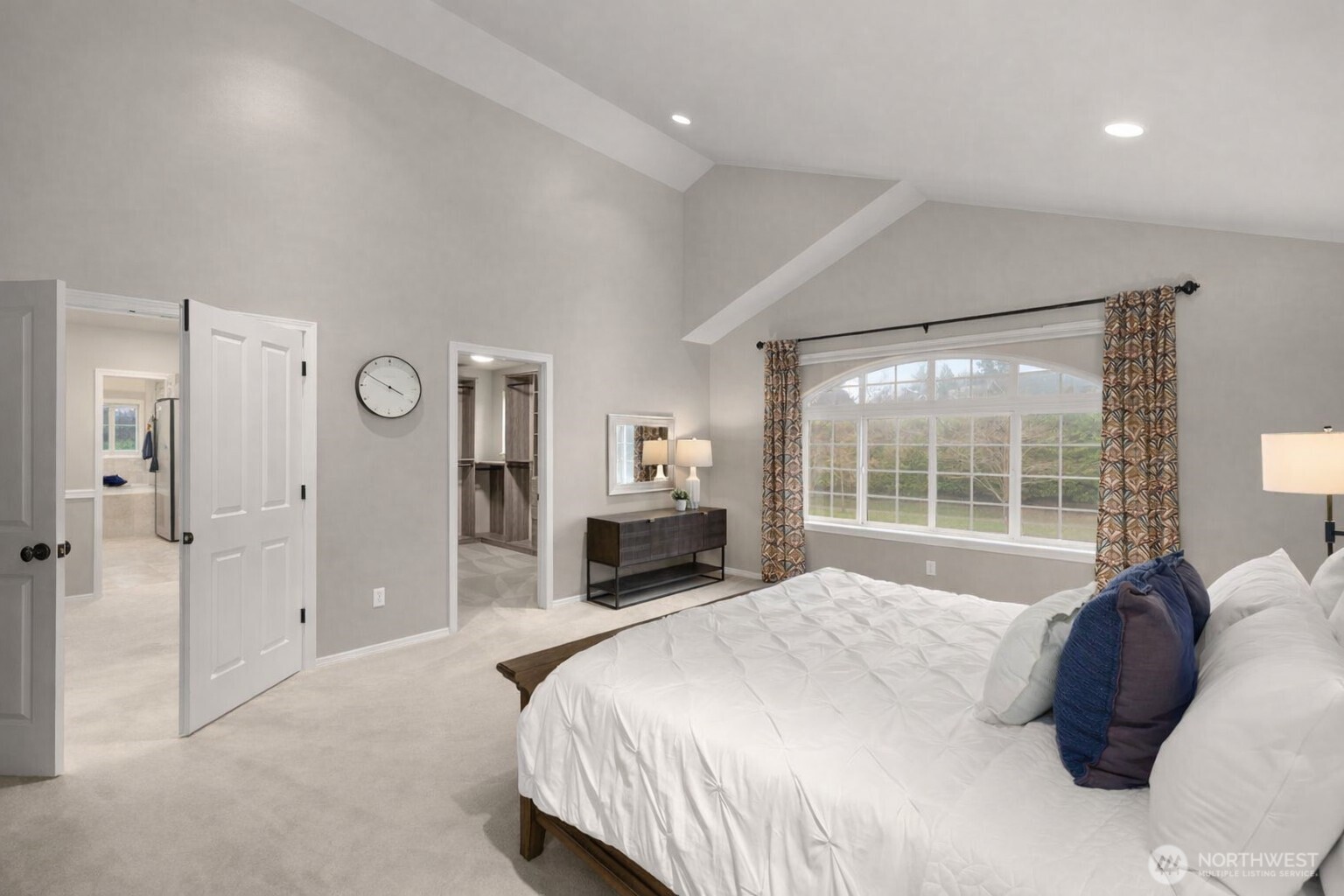 8360 Loyal Way Northwest Seattle, WA 98117 - Photo 18 of 36 a spacious bedroom with a large bed and a large window