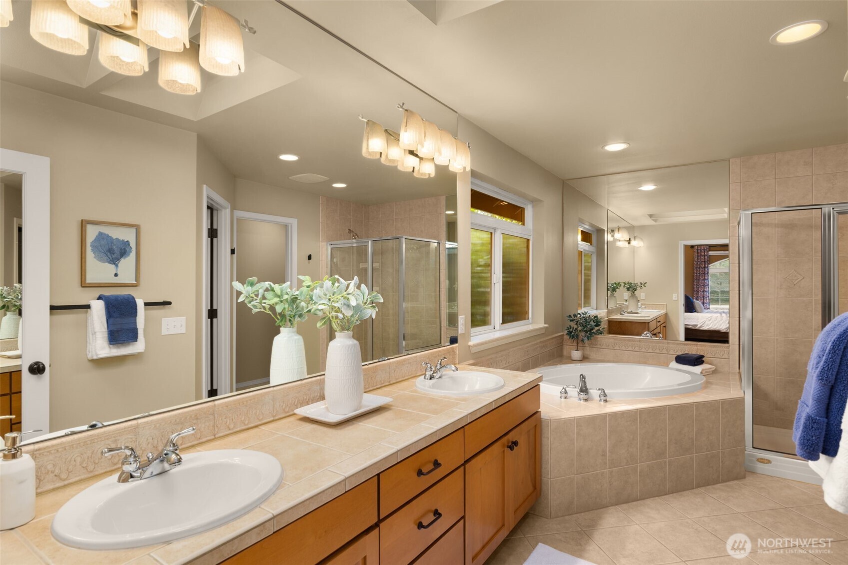 8360 Loyal Way Northwest Seattle, WA 98117 - Photo 20 of 36 a bathroom with a double vanity sink a large mirror and a bathtub