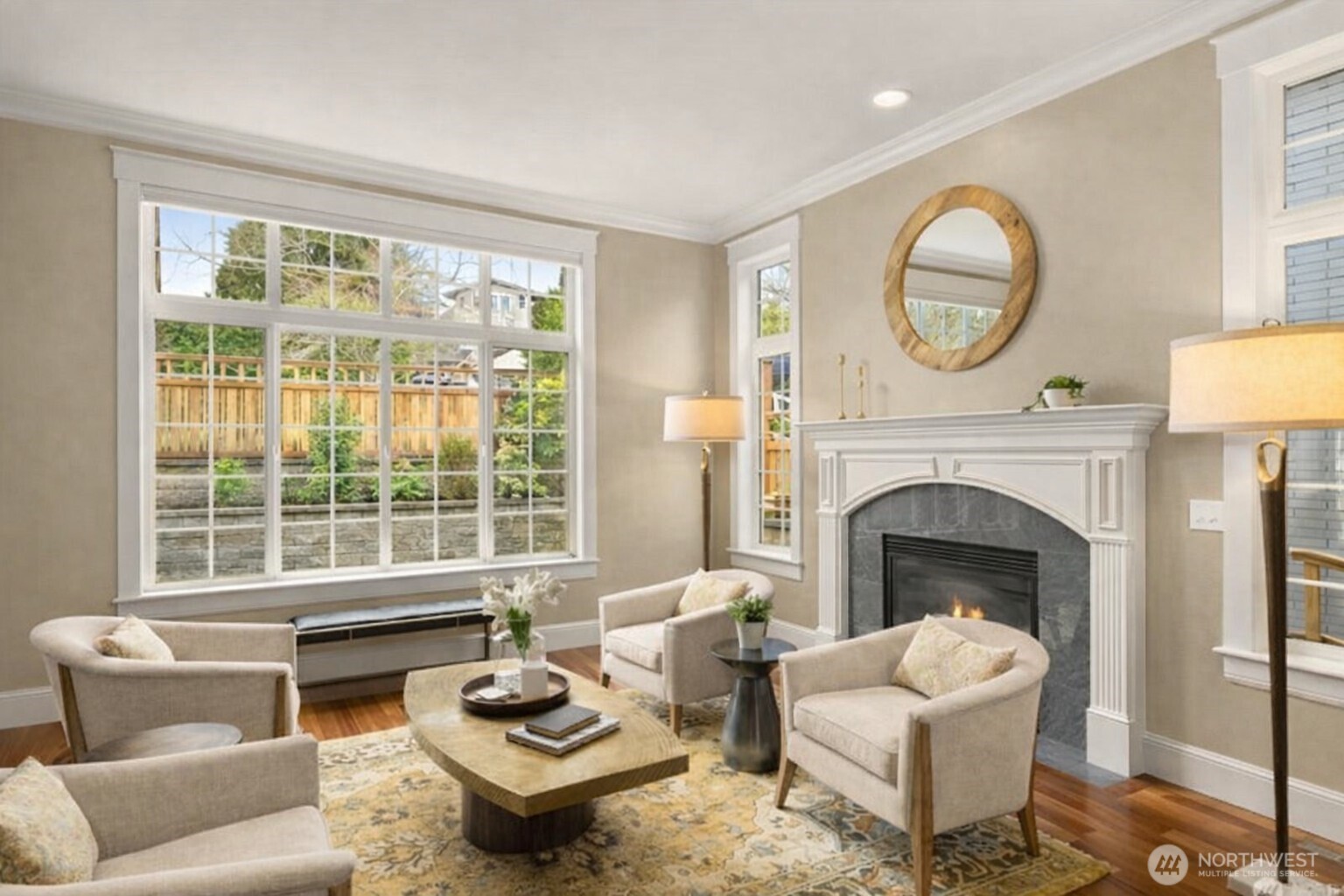 8360 Loyal Way Northwest Seattle, WA 98117 - Photo 2 of 36 a living room with furniture a fireplace and a large window