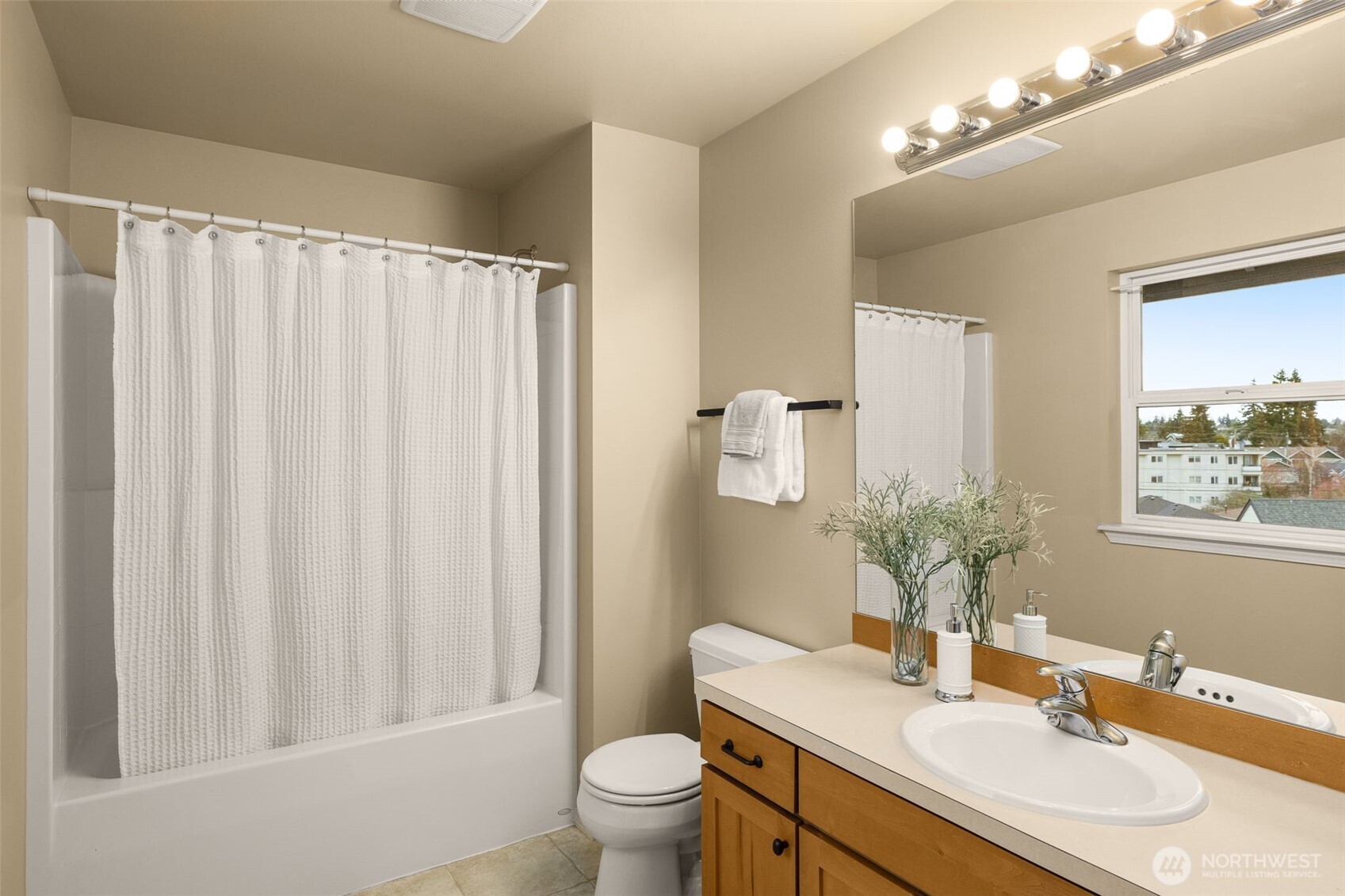 8360 Loyal Way Northwest Seattle, WA 98117 - Photo 23 of 36 a bathroom with a granite countertop sink toilet and mirror
