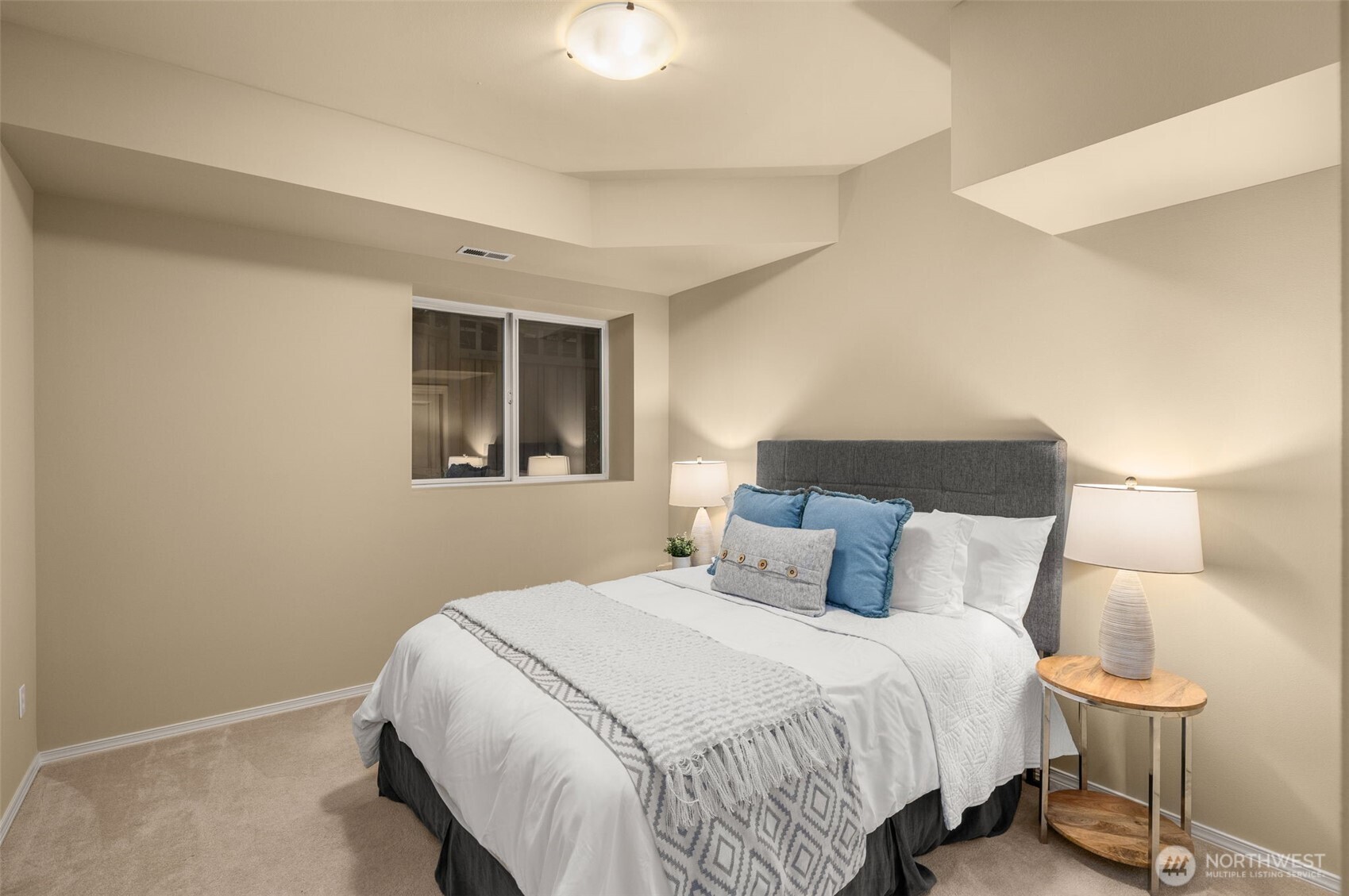 8360 Loyal Way Northwest Seattle, WA 98117 - Photo 27 of 36 a bedroom with a bed and a lamp