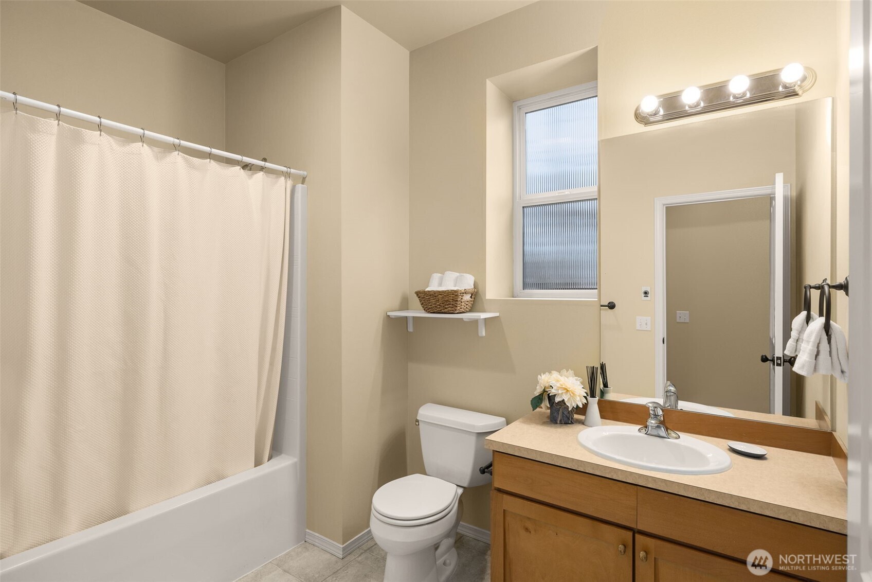 8360 Loyal Way Northwest Seattle, WA 98117 - Photo 28 of 36 a bathroom with a sink a toilet and a mirror