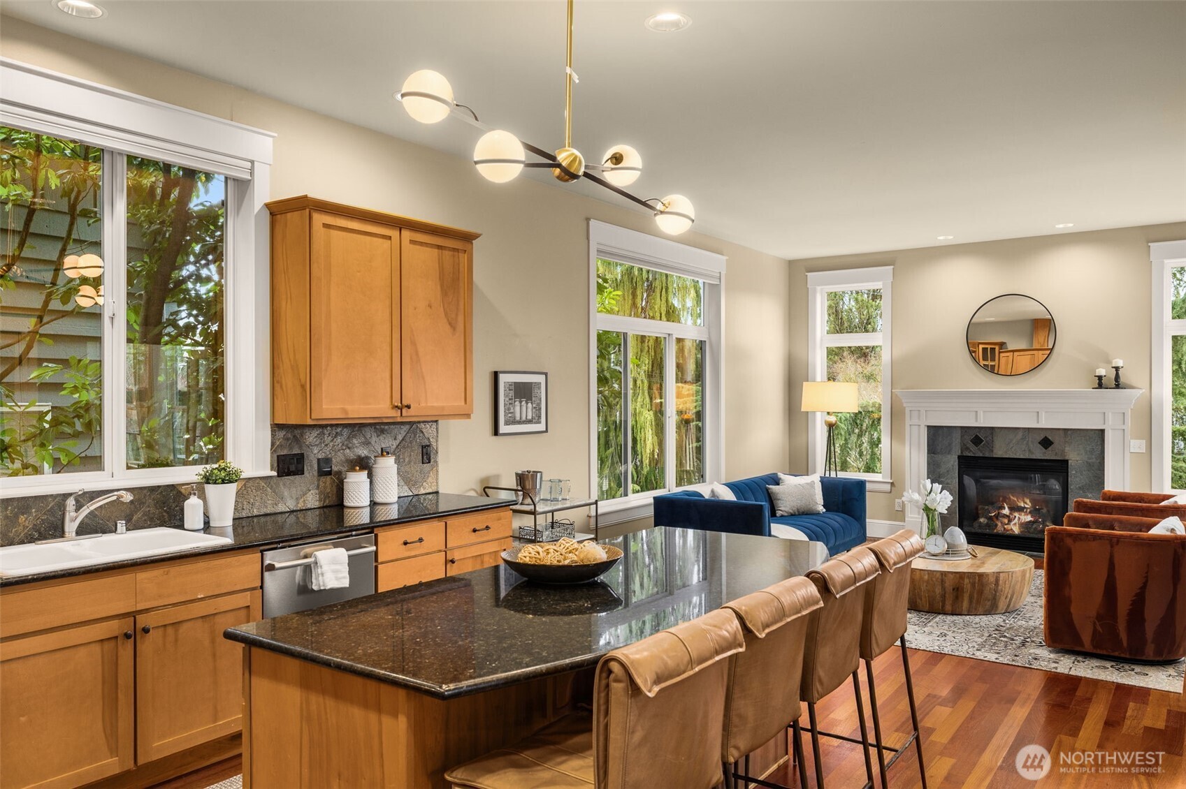 8360 Loyal Way Northwest Seattle, WA 98117 - Photo 6 of 36 a kitchen with a stove a sink a dining table and chairs
