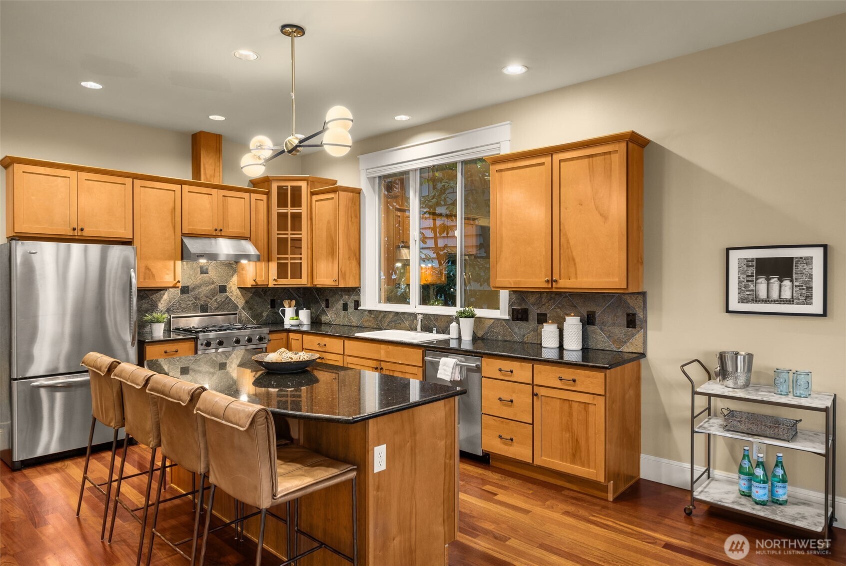 8360 Loyal Way Northwest Seattle, WA 98117 - Photo 10 of 36 a kitchen with granite countertop a sink appliances cabinets and furniture