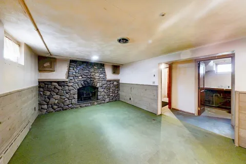 a view of an empty room with closet and cabinet