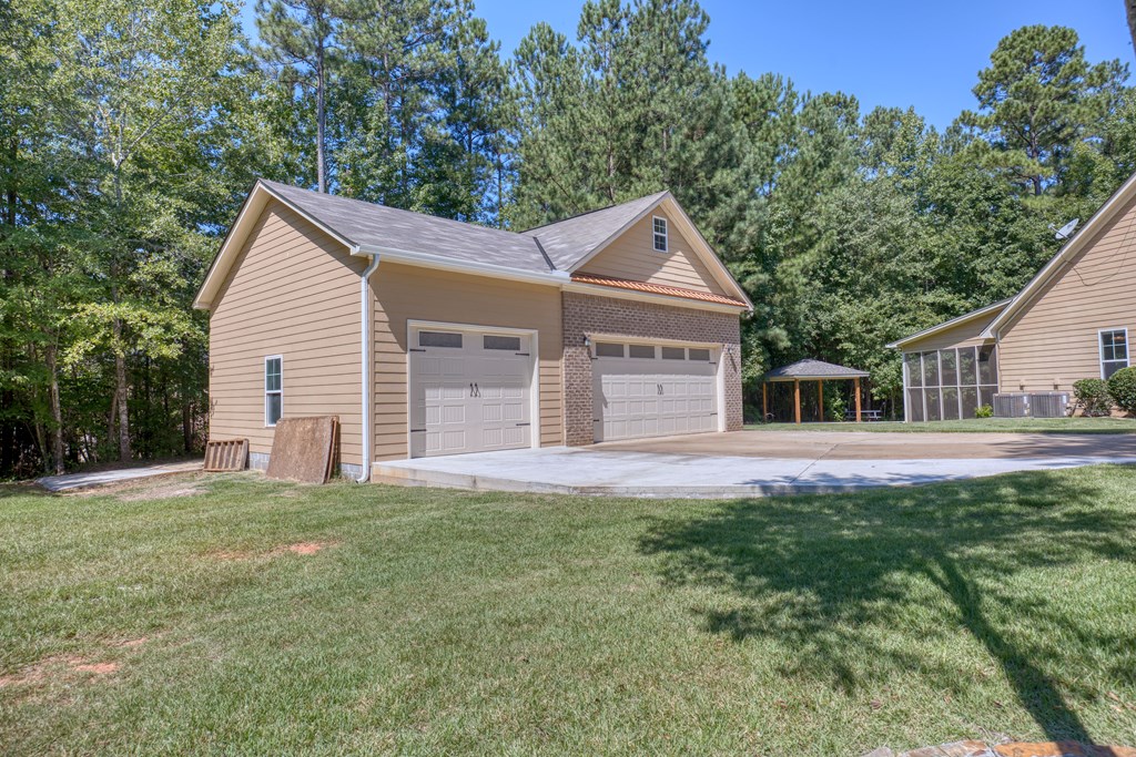 182 Oak Ridge Drive Waverly Hall, GA 31831 - Photo 12 of 52 a front view of a house with a yard and trees