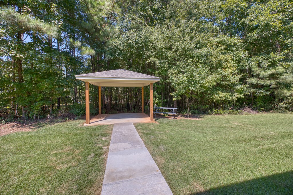 182 Oak Ridge Drive Waverly Hall, GA 31831 - Photo 19 of 52 a view of a table and chairs in backyard of the house