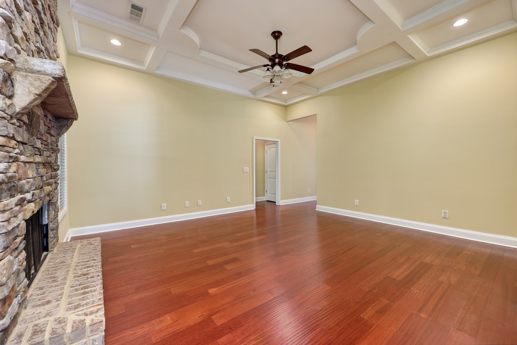 182 Oak Ridge Drive Waverly Hall, GA 31831 - Photo 23 of 52 a view of an empty room with wooden floor and a ceiling fan