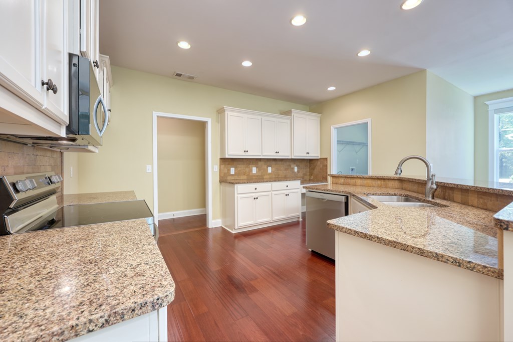 182 Oak Ridge Drive Waverly Hall, GA 31831 - Photo 27 of 52 a kitchen with stainless steel appliances granite countertop a sink a stove and a refrigerator