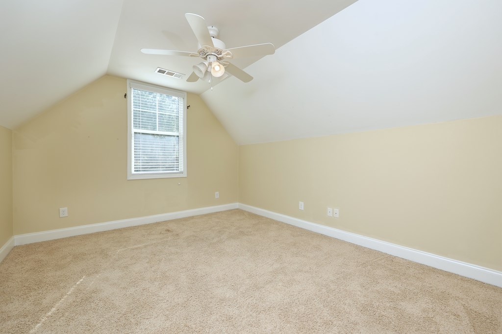 182 Oak Ridge Drive Waverly Hall, GA 31831 - Photo 40 of 52 an empty room with windows and chandelier fan