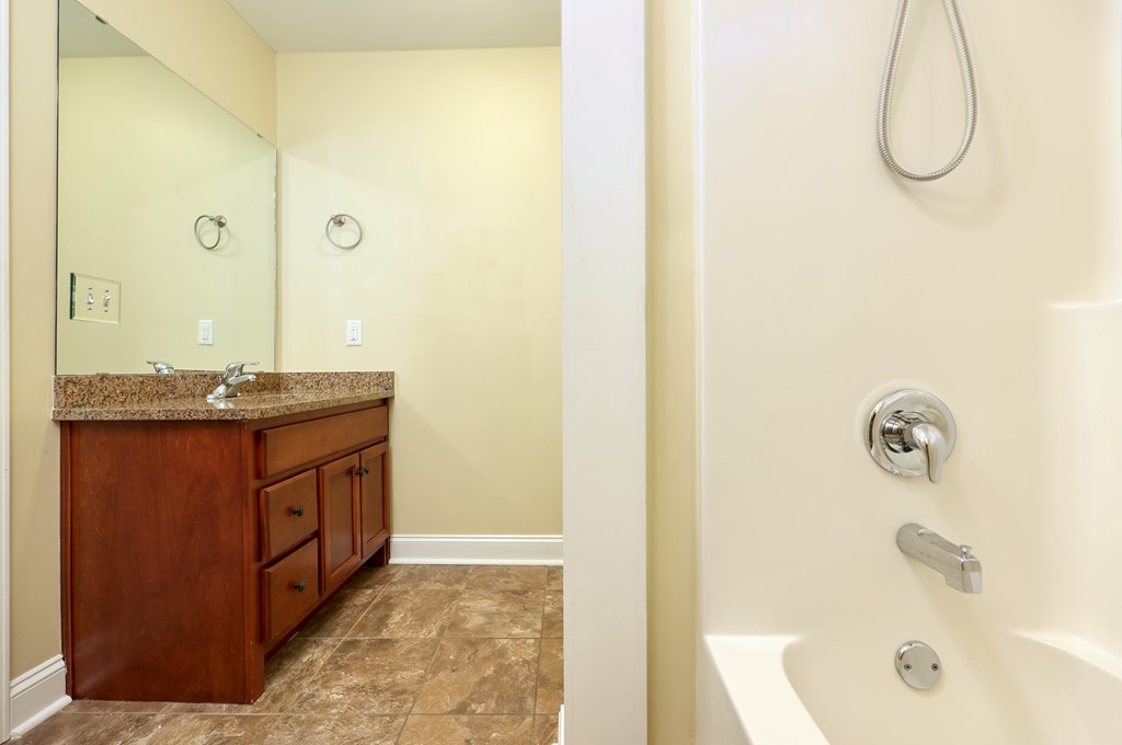 182 Oak Ridge Drive Waverly Hall, GA 31831 - Photo 42 of 52 a bathroom with a granite countertop sink and a mirror