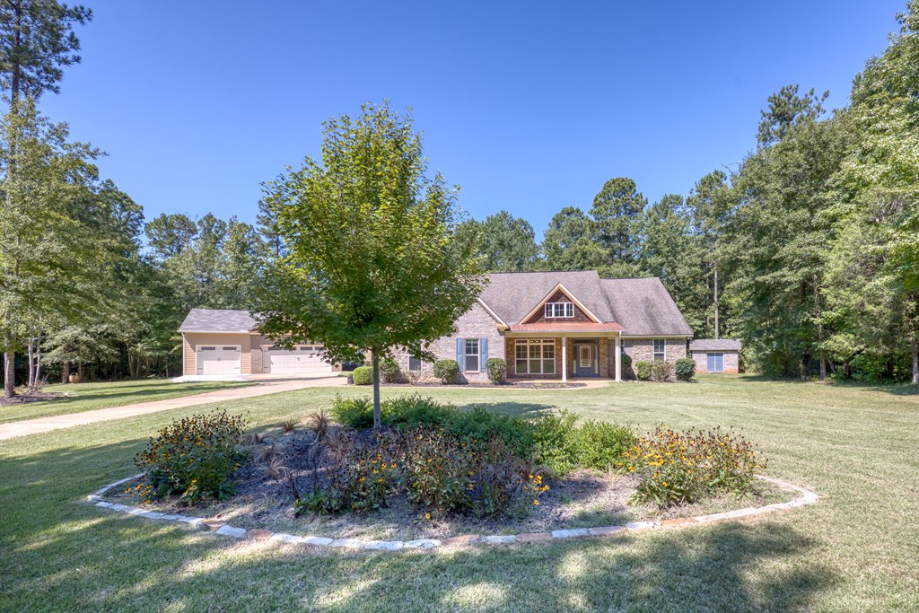 182 Oak Ridge Drive Waverly Hall, GA 31831 - Photo 6 of 52 a front view of a house with a yard and large trees